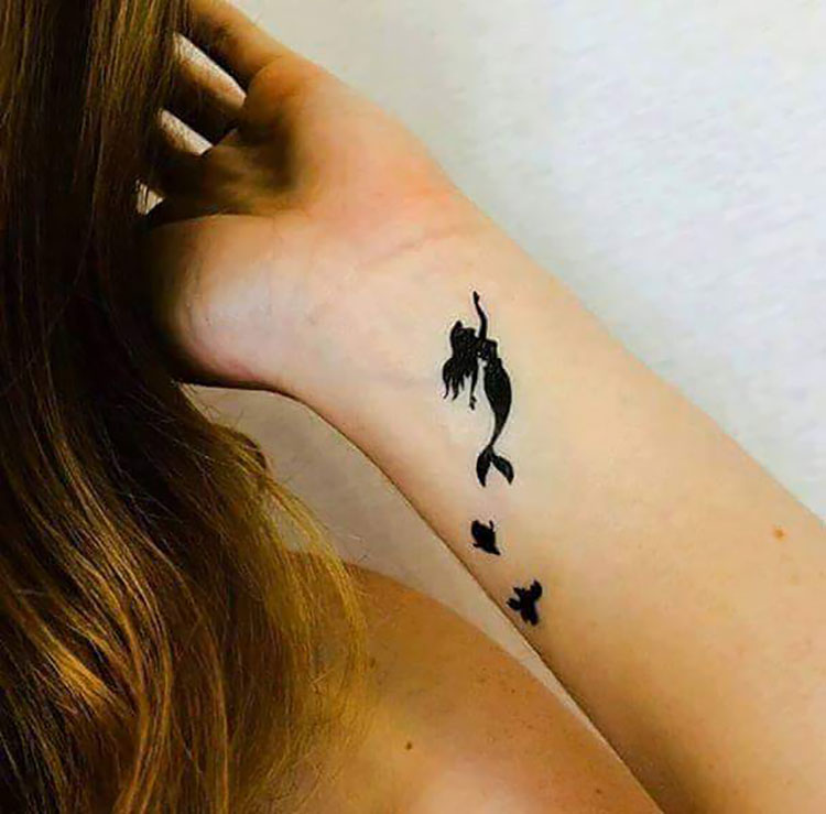 mermaid black tattoo on wrist