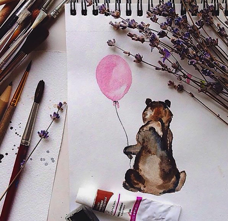 BEAR HOLDING A BALLOON