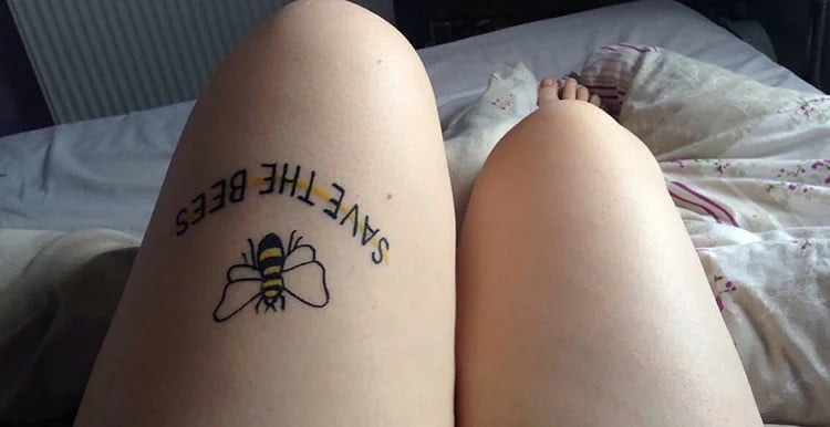 leg tattoo says save the bees