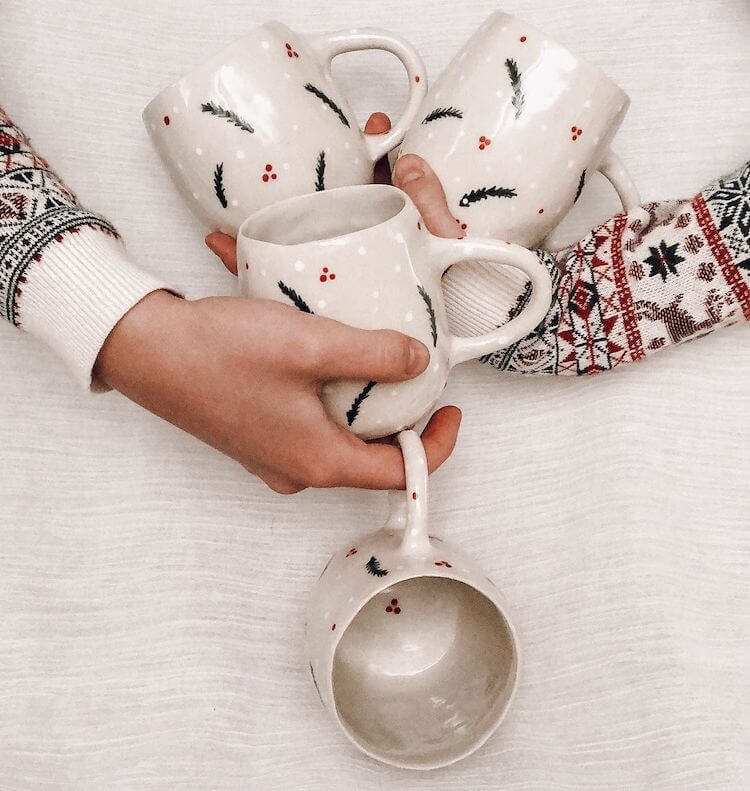 woman holding mugs