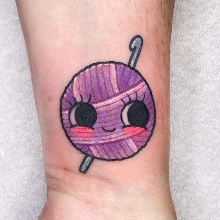 yarn ball tattoo with smile