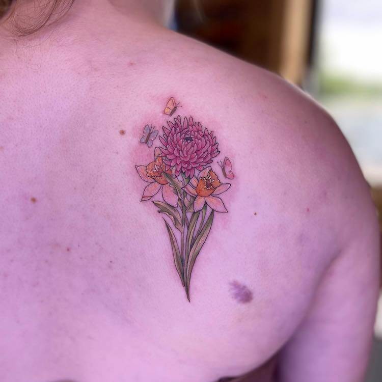 The Tackle Box Tattoo Parlor  Cool story behind this tattoothe  Chrysanthemum represents the birth month of my customer the Daffodils  represent her husbands brother and the Poppies in the middle represent