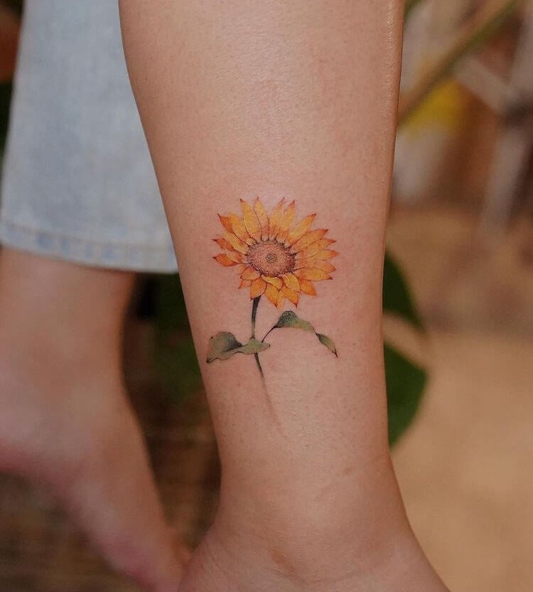 Watercolor sunflower tattoo on the bicep